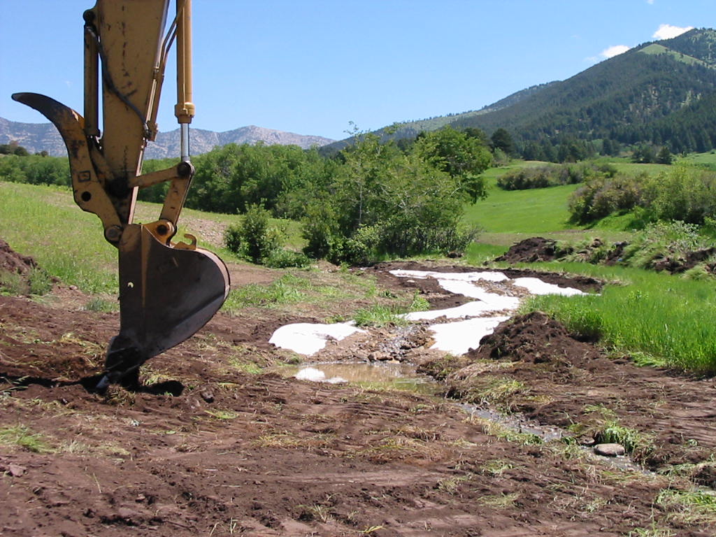 Clay geotextile lining along spring creek bank during restoration